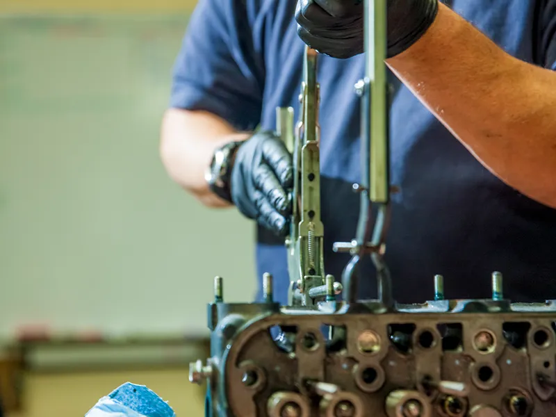Kubota Engines employee servicing an engine.