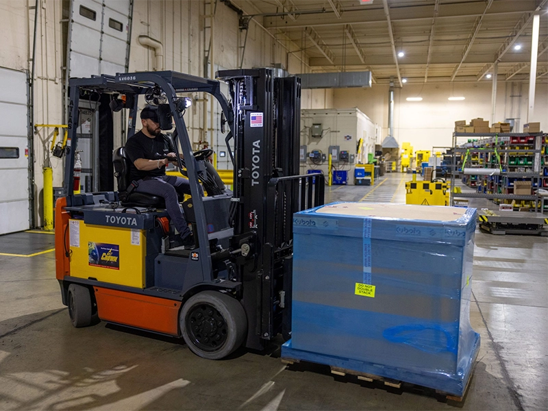Kubota warehouse forklift transporting palletized parts for efficient kitting and distribution operations