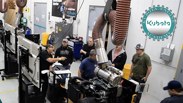 Kubota Engine Academy instructor-led service training class with technicians diagnosing Kubota engines in a hands-on workshop environment.